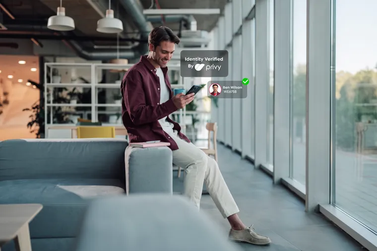 A man checking his phone beside an “Identity Verified by Privy” confirmation card