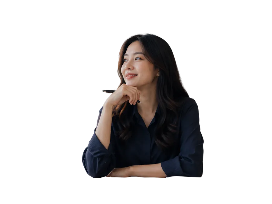 A smiling woman resting her chin on her hand, thinking