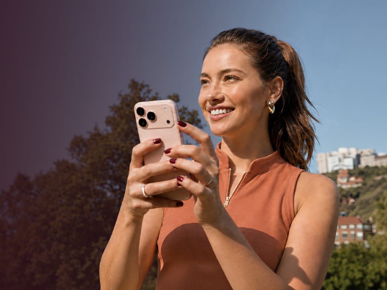 A woman using her phone outdoors on a clear day