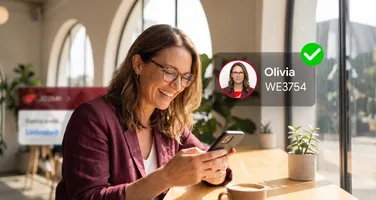 A woman smiling at her phone beside a verified identity card for Olivia