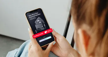 Hands holding a phone showing a “Continue with Privy” sign-in